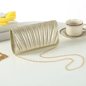 Elegant gold pleated evening clutch bag with chain strap for women party prom wedding use.