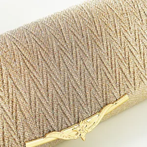 Close-up of golden glitter evening clutch bag with elegant metallic clasp for weddings.