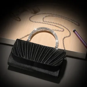 Elegant black pleated evening bag with sparkling rhinestone handle and chain for parties.