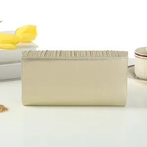 Gold pleated evening clutch bag, elegant metallic top-handle handbag for women parties.