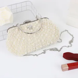Exquisite pearl evening clutch detail, featuring delicate white pearls and metal chain.