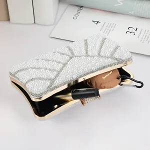 Close-up view of a stunning pearl evening clutch bag with elegant metal frame details.