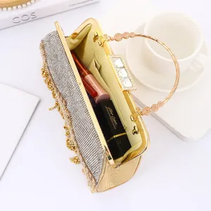 Elegant rhinestone evening clutch bag with metallic handle and sparkling tassel for banquets.