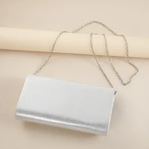 Silver metallic evening shoulder bag, elegant chain clutch for phone and lipstick detail.
