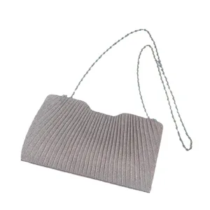 Detail shot of the stylish pleated evening bag with metallic chain strap for women.