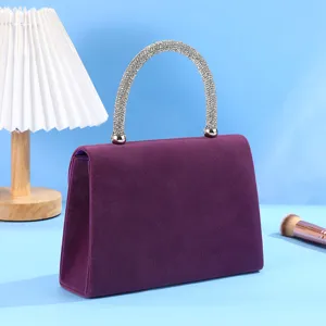 Purple suede evening handbag with sparkling rhinestone handle, elegant dress matching accessory.