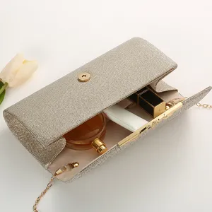 Close-up of champagne glitter evening clutch bag open with delicate chain and luxury props.