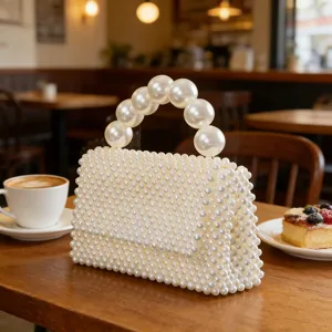 Handcrafted pearl beaded evening handbag with elegant large pearl handle detail view