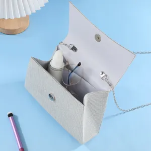 Detail view of silver glitter evening clutch bag, elegant party handbag close-up showcase.
