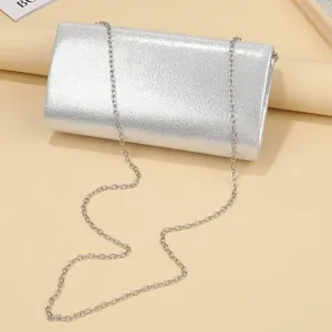 Silver glitter evening bag close-up showing shimmery texture and chain strap details.