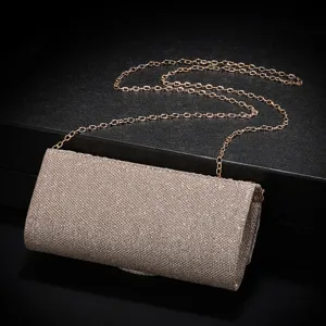 Glitter evening clutch bag detail view, sparkling texture surface and metallic chain strap.
