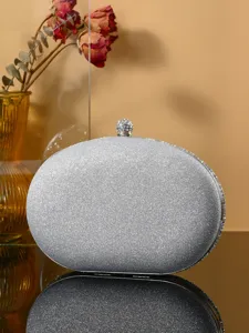 Silver glitter evening clutch bag detail, elegant rhinestone clasp for party and wedding dress.