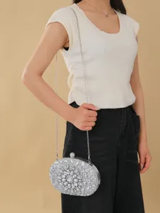 Elegant silver rhinestone oval evening clutch bag with chain strap for women party dresses.