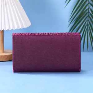 Close-up detail of the elegant purple satin pleated evening clutch bag for formal banquet events.