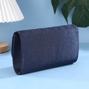 Blue glitter evening clutch bag detail view, shimmering pleated design for women party dress.