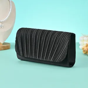 Elegant black pleated evening clutch bag, stylish handbag detail for parties and banquets.