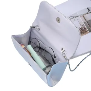 Elegant light blue evening clutch bag with chain strap, perfect for parties and formal events.