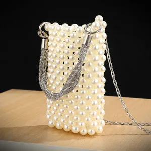 Pearl beaded phone bag detail showing rhinestone handle and delicate metal chain strap close-up.