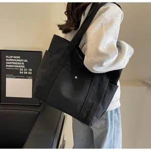 Large capacity black canvas shoulder bag for women, casual tote handbag for daily commute.