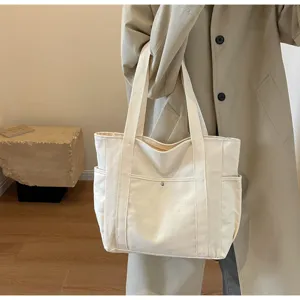 Large capacity canvas shoulder bag, casual tote for daily commuting, student book bag style.