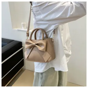 Detail view of khaki shoulder bag with stylish bow, showing texture and elegant daily wear.
