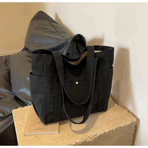 Black canvas tote bag for women, large capacity shoulder bag for student daily commuting and school.