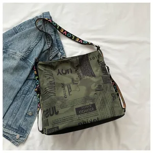 Detailed view of the casual oxford cloth shoulder bag with stylish letter print straps.