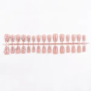 Set de uñas postizas ojo de gato rosa con diamantes de imitación y mariposas brillantes.