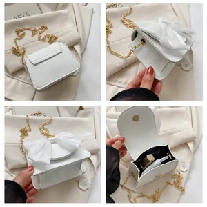 White mini crossbody bag for women with elegant bowknot and gold chain detail, stylish and cute.