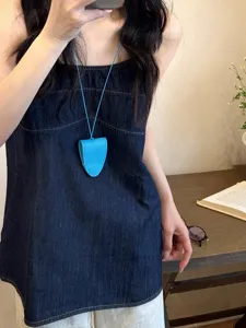 Blue leather glasses holder necklace close up detail shot, chic minimalist fashion accessory.