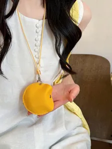 Yellow leather glasses pouch necklace detail view, stylish lanyard accessory for daily wear.