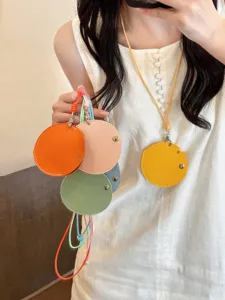 Leather glasses pouch necklace detail, stylish round mini bag pendant with lanyard for women.