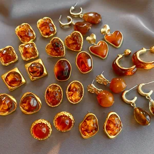 Detailed shot of vintage amber resin geometric earrings collection with gold finish.