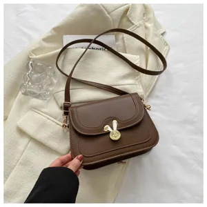 Chic brown PU leather crossbody shoulder bag for women with cute bunny ear elegant metal clasp.