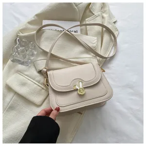 Elegant beige shoulder crossbody bag with cute metal rabbit lock for women daily wear.