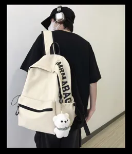 Casual canvas backpack for women, solid color minimalist school bag with cute bear pendant.