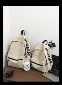 Korean style minimalist solid color canvas school backpack detail view, casual student daypack.