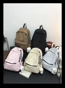 Casual multi-color canvas student school backpack with cute bear pendant for daily use.