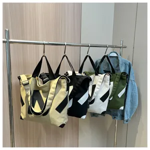 Canvas tote shoulder bag with geometric print, casual student crossbody bag in multi colors.