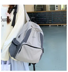 Detailed view of the casual grey canvas school backpack, showing multi-pocket design and wear.