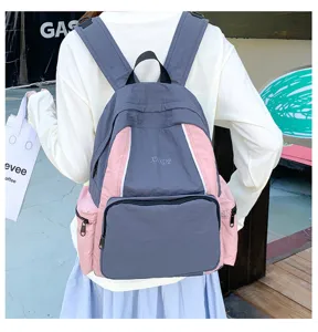 Detailed view of the stylish contrast color school backpack with front and side pockets.