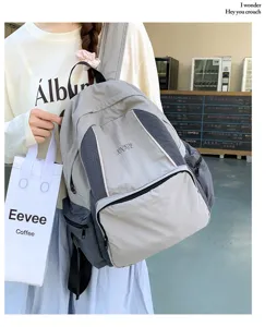 Casual grey canvas backpack with multiple compartments for daily student school and outdoor travel use.