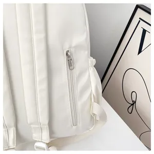 Solid white casual backpack detail shot showing vertical zipper pocket and shoulder straps.