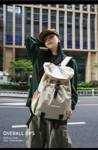 Casual beige canvas backpack for daily commute and travel, lightweight and durable.
