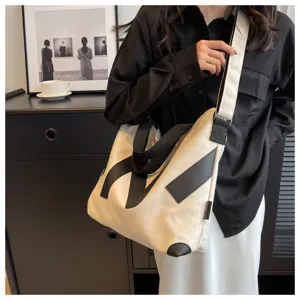 Canvas shoulder bag for women, large capacity crossbody tote bag with chic graphic design.