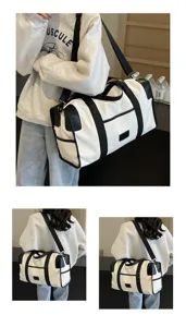 Detailed view of a stylish black and white color-block large capacity travel duffel shoulder bag.