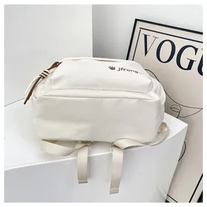 Detailed view of a white casual school backpack with cute paw print and adjustable straps.
