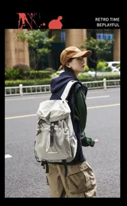 Outdoor lifestyle detail shot of casual travel backpack featuring waterproof grey fabric and multi pockets.