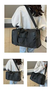 Detailed view of the black travel duffel bag showing comfortable strap and large capacity design.