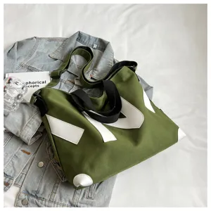 Casual Japanese style green canvas tote bag featuring contrast white patches and black straps.